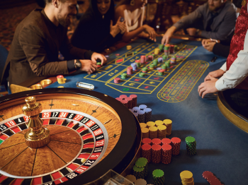 Hand of a croupier on a roulette wheel in a casino